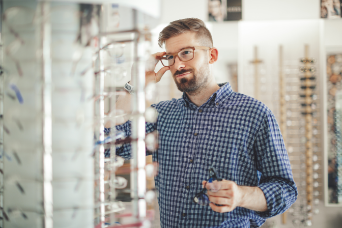 Man trying on glasses